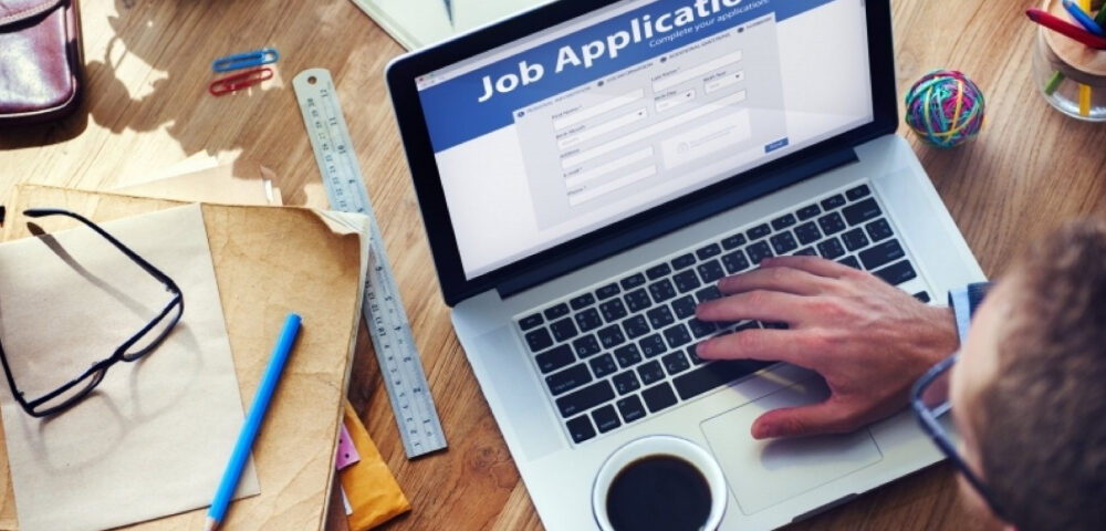 A Recruiter Checking With His Laptop About A Job Application.