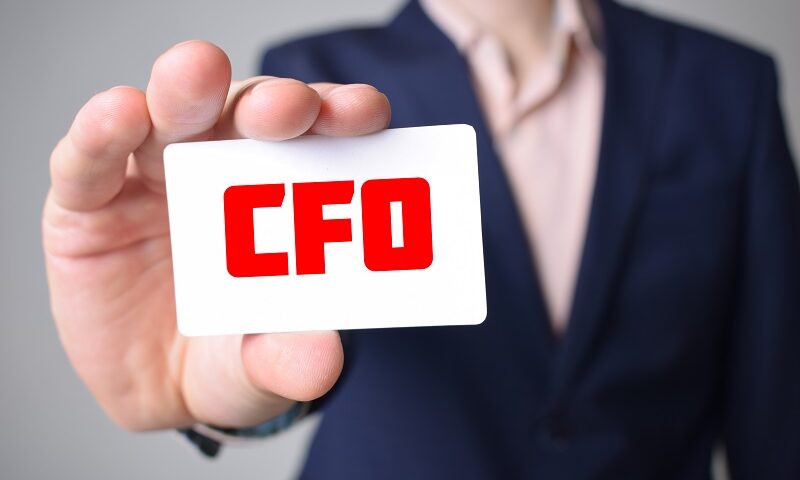 A business man holding CFO card.