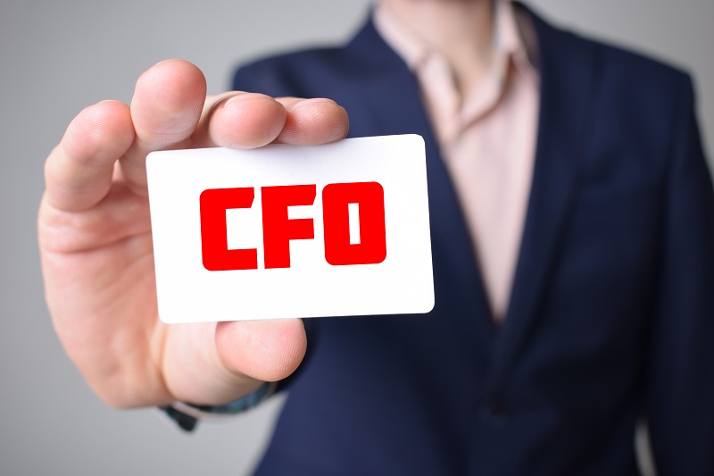 A business man holding CFO card.